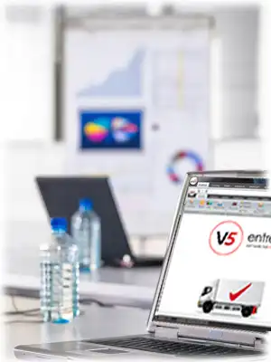 entrée v5 software on laptop in an office with water bottles and charts behind it