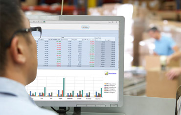 man sitting at computer looking at data statistics